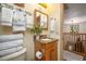Bathroom featuring granite counter and wood vanity, with a view of the staircase to the second floor at 4949 Lake Kotsa Dr, Lake Wales, FL 33898
