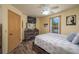 Bright bedroom boasts a TV, wood-look floors, a window, and a neutral color palette at 4949 Lake Kotsa Dr, Lake Wales, FL 33898