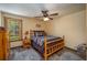 Bedroom featuring a rustic wood bed and furniture, area rugs, and a ceiling fan with a light at 4949 Lake Kotsa Dr, Lake Wales, FL 33898