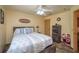 Inviting bedroom showcasing ample space, window, wood-look floors, ceiling fan and warm paint at 4949 Lake Kotsa Dr, Lake Wales, FL 33898