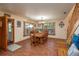 Large dining room featuring a wood table with seating for eight and views from three large windows at 4949 Lake Kotsa Dr, Lake Wales, FL 33898
