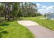 Concrete pad and driveway on a grassy lawn that leads to a paved road at 4949 Lake Kotsa Dr, Lake Wales, FL 33898