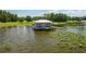 Charming lake house with metal roof, built on stilts, surrounded by water and lily pads at 4949 Lake Kotsa Dr, Lake Wales, FL 33898
