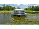 Charming lake house with a metal roof, built on stilts for stunning water views at 4949 Lake Kotsa Dr, Lake Wales, FL 33898