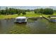 Exterior aerial view featuring a lake house, a dock and lush greenery surrounding the property at 4949 Lake Kotsa Dr, Lake Wales, FL 33898
