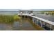 Waterfront lake house featuring a long dock, perfect for enjoying lake activities and serene views at 4949 Lake Kotsa Dr, Lake Wales, FL 33898