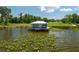 Scenic lake house featuring a metal roof, inviting porch and serene waterfront views at 4949 Lake Kotsa Dr, Lake Wales, FL 33898
