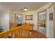 Upstairs hallway with wood floors features views into two bedrooms with wood doors at 4949 Lake Kotsa Dr, Lake Wales, FL 33898