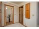 Hallway with neutral walls and carpet, featuring multiple doorways and a tall vase with decorative twigs at 4949 Lake Kotsa Dr, Lake Wales, FL 33898