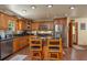 Traditional kitchen boasts wood cabinets, stainless appliances, and a granite island with seating at 4949 Lake Kotsa Dr, Lake Wales, FL 33898