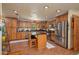 Spacious kitchen features wood cabinets, stainless appliances, granite counters, and an island with bar stool seating at 4949 Lake Kotsa Dr, Lake Wales, FL 33898