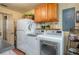 The laundry room boasts a refrigerator, washer, and dryer with overhead storage at 4949 Lake Kotsa Dr, Lake Wales, FL 33898