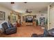 Cozy living room features built-in shelving, natural light and comfortable leather seating at 4949 Lake Kotsa Dr, Lake Wales, FL 33898