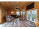 Bright living room with wood paneled walls, vinyl floors, and comfortable seating at 4949 Lake Kotsa Dr, Lake Wales, FL 33898