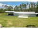 Large outbuilding with ample storage space, set on a sprawling green lawn in a tranquil setting at 4949 Lake Kotsa Dr, Lake Wales, FL 33898