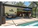 Enjoy outdoor living in this screened-in pool area with a dining table and comfortable seating at 4949 Lake Kotsa Dr, Lake Wales, FL 33898