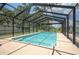 A large, screened-in pool area perfect for relaxation and recreation, with a spacious deck at 4949 Lake Kotsa Dr, Lake Wales, FL 33898