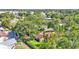 Aerial view showcasing the property's mature trees, neighborhood, and in-ground swimming pool at 527 Duchess Dr, Lakeland, FL 33803