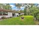 Spacious backyard featuring well-manicured lawn, patio seating, and a fire pit at 527 Duchess Dr, Lakeland, FL 33803