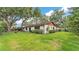 Well-maintained backyard with green grass, established trees and shrubs at 527 Duchess Dr, Lakeland, FL 33803