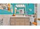 Bathroom featuring blue walls, nautical decorations, a mirror, and vanity storage at 527 Duchess Dr, Lakeland, FL 33803