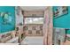 Bathroom featuring a tile shower, blue walls, and nautical themed decor at 527 Duchess Dr, Lakeland, FL 33803