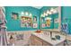 Bathroom with blue walls, tile backsplash, decorations, and under cabinet storage at 527 Duchess Dr, Lakeland, FL 33803