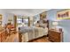 Bedroom with blue walls, hardwood floors, decor, and a queen sized bed at 527 Duchess Dr, Lakeland, FL 33803