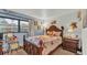 Bedroom with floral bedding, wooden furniture, carpet, and a large window at 527 Duchess Dr, Lakeland, FL 33803