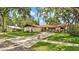 Well-maintained home with mature trees, landscaped yard, and long driveway at 527 Duchess Dr, Lakeland, FL 33803