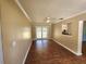 Bright dining room with wood floors and a ceiling fan, with access to patio area at 550 E Thelma St, Lake Alfred, FL 33850