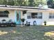 Charming home exterior featuring a well-manicured lawn, plants, and a decorative front door at 550 E Thelma St, Lake Alfred, FL 33850