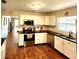 Bright kitchen features stainless steel appliances, white cabinets, and black countertops, perfect for cooking at 550 E Thelma St, Lake Alfred, FL 33850