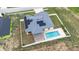High-angle shot showcasing home with solar panels, pool, and fenced backyard at 607 S 16Th St, Haines City, FL 33844