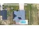 Aerial view of home showing backyard with pool and solar panels on roof at 607 S 16Th St, Haines City, FL 33844