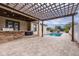 Paver patio with outdoor kitchen, pool, and pergola enhance the backyard living space at 607 S 16Th St, Haines City, FL 33844