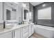 Luxurious bathroom featuring dual sinks, bathtub, and modern fixtures and finishes at 607 S 16Th St, Haines City, FL 33844
