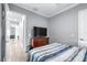 Neutral bedroom with a large television and wood-look flooring; great natural light throughout at 607 S 16Th St, Haines City, FL 33844