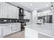 Modern kitchen featuring white cabinetry, mosaic backsplash, stainless steel appliances, and spacious countertops at 607 S 16Th St, Haines City, FL 33844