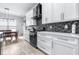 Bright kitchen features white cabinetry, wood-look floors, mosaic backsplash and stainless appliances at 607 S 16Th St, Haines City, FL 33844