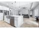 Bright modern kitchen with stainless steel appliances, white cabinets, and an island with a stainless sink at 607 S 16Th St, Haines City, FL 33844