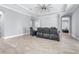Spacious living room featuring neutral paint, tile floors, a tray ceiling, and recessed lighting at 607 S 16Th St, Haines City, FL 33844