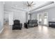 Spacious living room featuring neutral paint, tile floors, a tray ceiling, and recessed lighting at 607 S 16Th St, Haines City, FL 33844