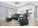 Open-concept living room and kitchen featuring neutral paint, modern lighting, tile floors, and a tray ceiling at 607 S 16Th St, Haines City, FL 33844