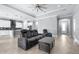 Open-concept living room and kitchen featuring neutral paint, modern lighting, tile floors, and a tray ceiling at 607 S 16Th St, Haines City, FL 33844