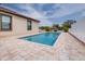 Beautiful pool featuring modern pavers, surrounded by lush greenery, perfect for relaxation at 607 S 16Th St, Haines City, FL 33844