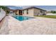 Beautiful backyard pool with lush greenery and modern patio for outdoor enjoyment at 607 S 16Th St, Haines City, FL 33844