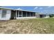 Backyard view of an enclosed lanai and a partially grassy lawn at 615 Ridge Ter # 615, Winter Haven, FL 33881