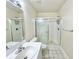 Well-lit bathroom featuring a white vanity with a modern sink and a glass-enclosed shower at 615 Ridge Ter # 615, Winter Haven, FL 33881