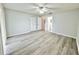 Well-lit bedroom with closet, ceiling fan, wood-look flooring, and a view to the en-suite bathroom at 615 Ridge Ter # 615, Winter Haven, FL 33881